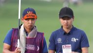 South Korea's Wang Jeunghun (R) competes in the Qatar Masters golf tournament at the Doha Golf Club in Doha on January 28, 2017. (AFP / KARIM JAAFAR)