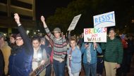 People hold banners and candles during the candlelight vigil held to protest against President Donald Trump's decision for a wall between Mexico and US borders and over visa ban for some Muslim countries in Los Angeles, CA, USA on January 26, 2017. (Aydin