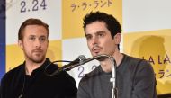 US film director Damien Chazelle (R) answers questions as Canadian actor Ryan Gosling (L) looks on during a press conference for their film 