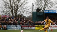 Sutton United's English defender Jamie Collins scores the opening goal from the penalty spot during the English FA Cup fourth round football match between Sutton United and Leeds United at the Borough Sports Ground in London on January 29, 2017.  AFP / Ad
