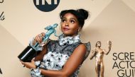 Actress Janelle Monae poses backstage with her award for Outstanding Performance by a Cast in a Motion Picture for 