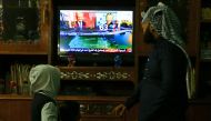 FILE PHOTO: An Iraqi family follows the US presidential elections on television at their home in Baghdad on November 8, 2016 (AFP) 