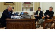 U.S. President Donald Trump (L), seated at his desk with National Security Advisor Michael Flynn (2nd R) and senior advisor Steve Bannon (R), speaks by phone with Australia's Prime Minister Malcolm Turnbull in the Oval Office at the White House in Washing