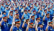 Police officers take oath at the Philippine National Police (PNP) headquarters in Quezon City, Metro Manila, yesterday.