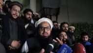 Hafiz Muhammad Saeed, chief of the banned Islamic charity Jamat-ud-Dawa, speaks with media as he is escorted to his home where he will be under house arrest in Lahore, Pakistan January 30, 2017. REUTERS/Stringer