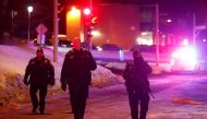Police officers patrol the perimeter near a mosque after a shooting in Quebec City, January 29, 2017. REUTERS/Mathieu Belanger.