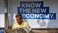 A man reads a newspaper as he waits for public transport at a bus stop in Mumbai, India, January 31, 2017. (REUTERS/Shailesh Andrade)
