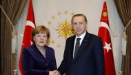 (FILES) This file photo taken on February 8, 2016 shows the President of Turkey Recep Tayyip Erdogan (R) and German Chancellor Angela Merkel (L) shaking hands during her visit at Presidential Complex in Ankara. Merkel will be on an official visit to Turke