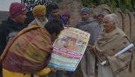 In this photograph taken on January 24, 2017, Indian activist Asha Rani, 76, carries posters during a campaign against drug addiction in a village near the town of Gurdaspur. AFP / Narinder Nanu
