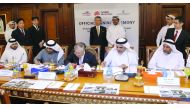 Minister of Energy and Industry H E Dr Mohammed bin Saleh Al Sada (standing at the back) witnessing the signing ceremony for the  5th amendment of the MoU of ‘The Partnership Project’ among QEWC, Kahramaa and Japan's Chubu at the Ministry's headquarters, 