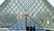 French police secure the site near the Louvre Pyramid in Paris, yesterday.