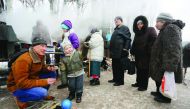 Residents queue for hot food distributed by Ukrainian rescue services in the flashpoint eastern town of Avdiivka, yesterday.