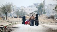People carry their belongings as they flee the Kadi Askar area towards Bustan al-Qasr neighbourhood, in rebel-held besieged Kadi Askar area of Aleppo, Syria December 5, 2016. REUTERS/Abdalrhman Ismail