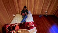 REPRESENTATIVE IMAGE: Ali Rasooli, a refugee from Afghanistan sits on his mattress reading a book in a house he rents with other refugees in the western Sydney suburb of Guildford, Australia, July 17, 2016 (REUTERS / David Gray) 