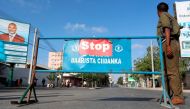 A Somali policeman stands guard along a road which was blocked to control motor vehicle traffic, during a security lock down in Somalia's capital Mogadishu, February 7, 2017. REUTERS/Feisal Omar
