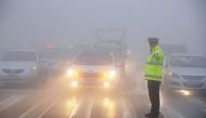 A traffic police works among heavy smog during a polluted day in Bozhou, Anhui province, China, February 5, 2017. REUTERS/Stringer