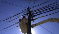 FILE PHOTO - A worker stands in a crane as he fixes electricity cables attached to a pole on a suburban street in Sydney, Australia, November 10, 2015. Reuters/David Gray/File Photo

