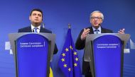 Ukraine's Prime Minister Volodymyr Groysman (left) and European Commission President Jean-Claude Juncker address a press conference after their meeting in Brussels, yesterday.