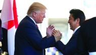 Japanese Prime Minister Shinzo Abe is greeted by US President Donald Trump ahead of their meeting and joint news conference at the White House, in Washington, yesterday.