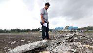 A man looks at the damaged runway of the dometic airport after a 6.5-magnitude earthquake struck overnight in Surigao City in southern island of Mindanao on February 11, 2017.  AFP / ERWIN MASCARINAS
