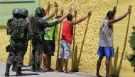 Army soldiers check people, during a military police strike over wages, while patrolling the streets of Vila Velha, Espirito Santo, Brazil, February 11, 2017. REUTERS/Paulo Whitaker