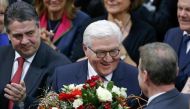 German president-elect, Frank-Walter Steinmeier, receives flowers after the first round of voting of the German presidential election at the Reichstag in Berlin, February 12, 2017. REUTERS/Hannibal Hanschke.