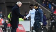 Swansea City's Nathan Dyer receives medical attention after sustaining an injury while Leicester City manager Claudio Ranieri looks on. Reuters / Rebecca Naden 
