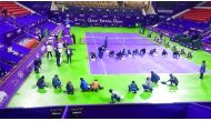 Workers mop up the playing surface as play was stopped due to rain during the Qatar Total Open at the International Khalifa Tennis Complex in Doha yesterday. Picture by Anvar Sadath
