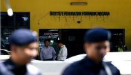 Malaysian police personnell stand guard outside the Forensic wing at the Hospital Kuala Lumpur in Kuala Lumpur on February 15, 2017 where the body of North Korean man suspected to be Kim Jong-Nam, half-brother of North Korean leader Kim Jong-Un is bieng k