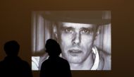 Visitors stand in front of the screen projecting videos of artist Joseph Beuys during the exhibition 'Beuys, We are the Revolution' at the The Hamburger Bahnhof museum for contemporary arts in Berlin October 1, 2008. REUTERS/Pawel Kopczynski