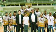 Winners of a group event pose for a photograph with officials of Alfardan Group during their National Sport Day celebrations at the Ali Bin Hamad Al Attiyah Arena on Tuesday.