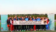 Participants of the Qatar Open Shotgun Championship hold a banner during National Sport Day celebrations at the Losail Shooting Complex on Tuesday. Around 300 shooters from 32 countries - including world champions and Olympic medal winners - are in action