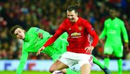 Manchester United's Swedish striker Zlatan Ibrahimovic is fouled by St Etienne's Ole during the UEFA Europa League Round of 32 first-leg match against Saint-Etienne at Old Trafford Stadium in Manchester, north-west England, on Thursday.