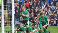 Lincoln City's English defender Sean Raggett (C) celebrates with teammates after scoring during the English FA Cup fifth round football match between Lincoln City and Burnley at the Sincil Bank stadium in Lincoln, eastern England, on February 18, 2017. (A