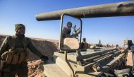 A picture taken on February 18, 2017 shows the reflection of a fighter manning a gun through the mirror of heavily-armed vehicle near the frontline village of Ayn al-Hisan, on the outskirts of Tal Afar west of Mosul, where Iraqi forces are preparing for t
