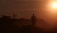 A Syrian Democratic Forces (SDF) fighter stands near a flag in northern Raqqa province, Syria February 6, 2017. REUTERS/Rodi Said