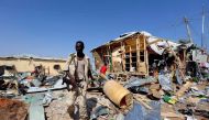 A Somali government soldier walks past the scene of a suicide bomb explosion at the Wadajir market in Madina district of Somalia's capital Mogadishu February 19, 2017. REUTERS/Feisal Omar