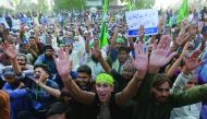 Supporters of the religious party Jamat Ehl-e-Sunnat chant slogans to condemn Thursday’s suicide blast at the tomb of Sufi saint Syed Usman Marwandi, also known as the Lal Shahbaz Qalandar shrine, during a protest rally near the Sindh Assembly Building in