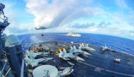 The aircraft carrier USS Carl Vinson participating in a replenishment-at-sea with the Black Knights of Helicopter Sea Combat Squadron 4 and the cargo and ammunition ship USNS Charles Drew (rear). The Vinson aircraft carrier strike group is patrolling the 