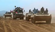 Iraqi forces armoured vehicles, supported by the Hashed al-Shaabi (Popular Mobilisation) paramilitaries, advance towards the village of Sheikh Younis, south of Mosul, after the offensive to retake the western side of the city from Islamic State (IS) group