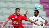 Youssef El Arabi (left) of Lekhwiya is locked in an aerial battle with an Al Jazira player during the AFC Champions League Group B opener at Abdullah Bin Khalifa Stadium in Doha yesterday. Lekhwiya won 3-0. 
