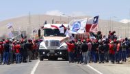 Workers of the Escondida copper mine block a road as they strike in Antofagasta, Chile, on February 20, 2017. AFP / Franceso DEGASPERI