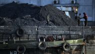 Coal laborers in 2013 in the North Korean town of Sinuiju, which is close to the Chinese city of Dandong. Credit Mark Ralston/Agence France-Presse.
