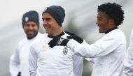 Juventus' forward Paulo Dybala from Argentina (L) and Juventus' midfielder Juan Cuadrado from Colombia (R) take part in a training session on the eve of the UEFA Champions League football match FC Porto Vs Juventus on February 21, 2017 at the 'Juventus Tr