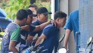 A North Korean man (R) identified by the Malaysian police as Ri Jong Chol and suspected by the authorities to be in connection with the murder of Kim Jong Nam, is taken to a police station in Sepang, Malaysia, February 18, 2017. Park Jung-ho/News1 via REU