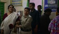 Indian police officials escort Chandana Chakraborty (L) from a police station in Jalpaiguri on February 21, 2017, for a medical check up to a hospital in the district of the eastern Indian state of West Bengal, after her arrest as part of an alleged child