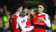 Arsenal's Theo Walcott (centre) celebrates with team-mates Lucas Perez and Gabriel Paulista after scoring their second goal against non-league minnows Sutton United in the FA Cup on Monday.