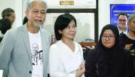 Pornpen Khongkachonkiet (centre), the chair of Amnesty International Thailand; Anchana Heemmina (right) and Somchai Homlaor show a document filed at the State Prosecutors office in Pattani, yesterday. 
