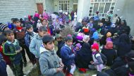 Iraqi families who fled the front line gather in the village of Al Buseif, south of Mosul, during an offensive by Iraqi forces to retake the western side of the city from Islamic State (IS) group fighters, yesterday.