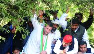 Chief Minister of the northern Indian state of Uttar Pradesh and Samajwadi Party leader Akhilesh Yadav (second right) and Congress Vice-President Rahul Gandhi (centre) pass under foliage as they take part in a joint roadshow in support of their state asse